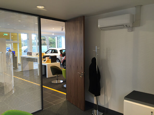 A discreet air conditioning unit in a commercial car showroom 